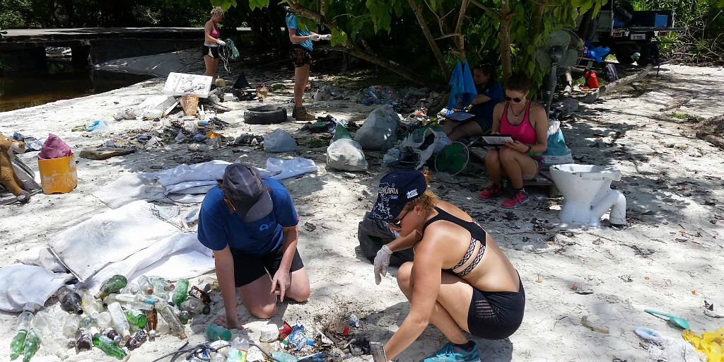 Volunteers picking up litter on a beach.