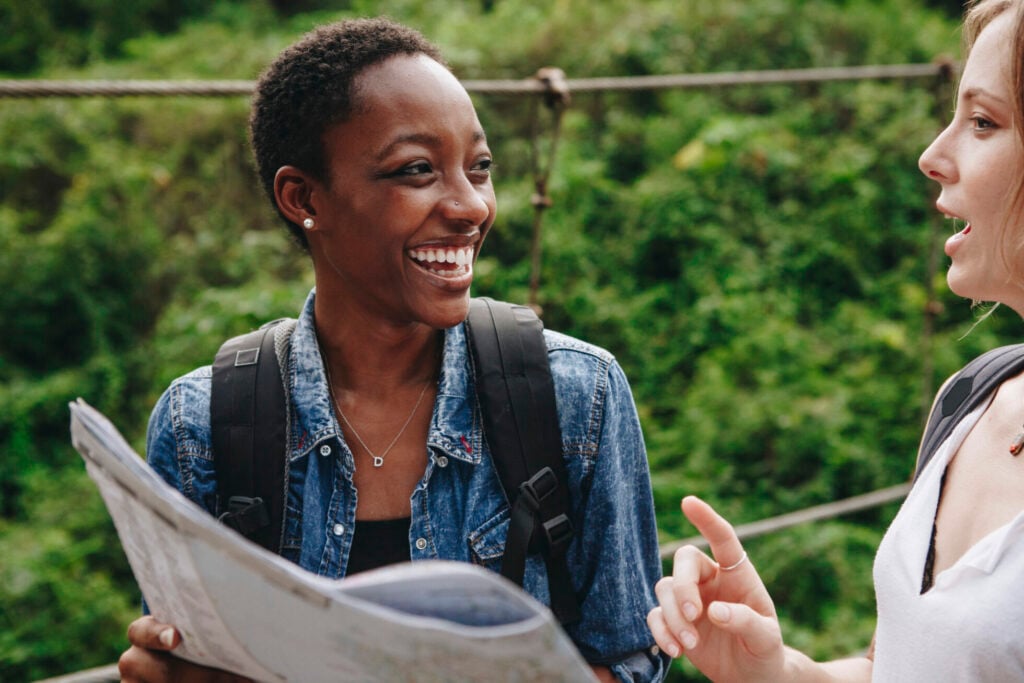 Happy woman navigating with a map