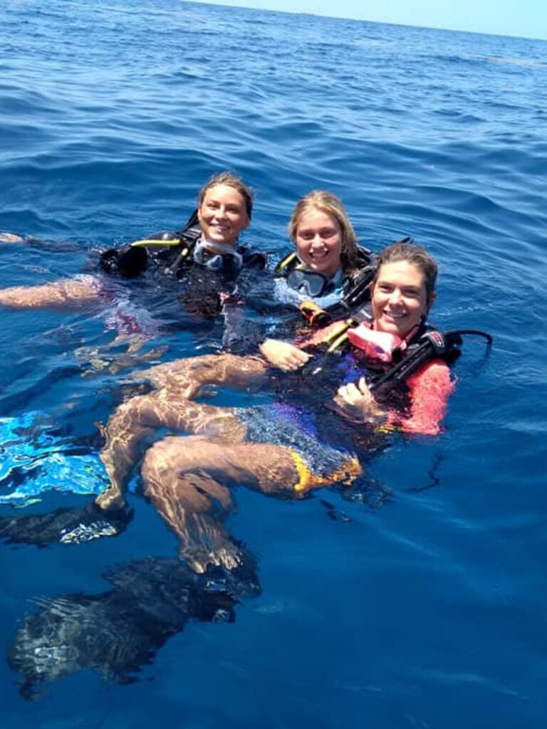 Three young women diving in the ocean