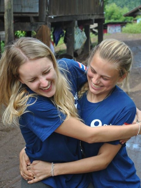 Two young women hugging