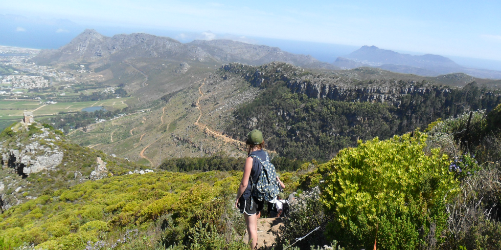 A hiker looking out over the view from a mountaintop.