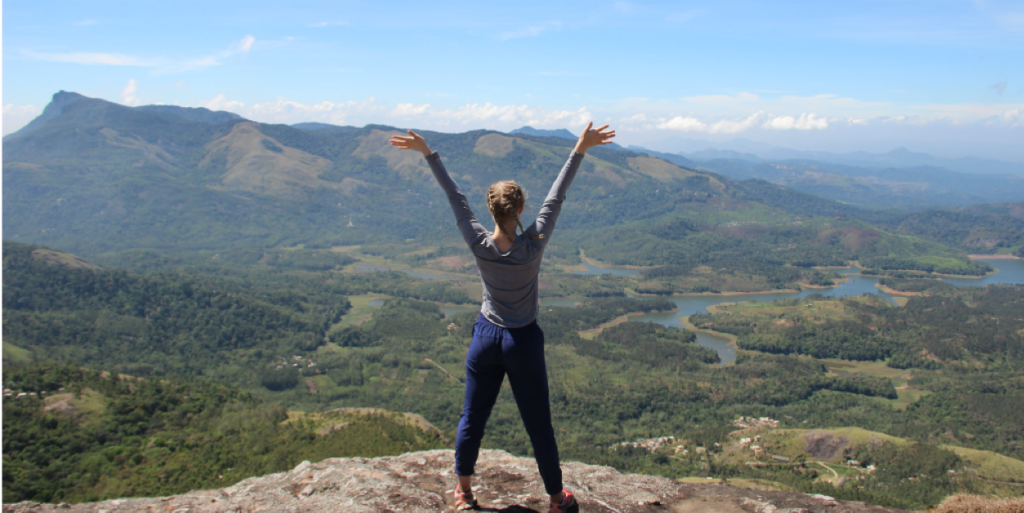 Woman at the top of a mountain