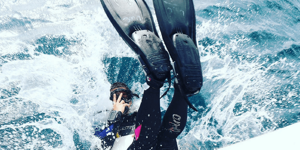 A volunteer scuba diving during a gap year adventure program.