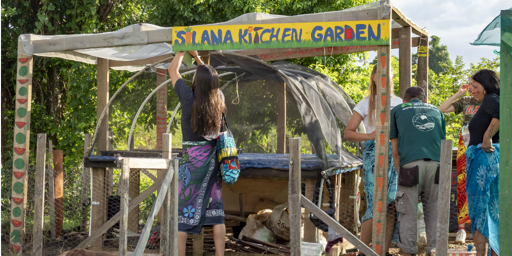 Volunteers assisting community members to set up a food garden in Dawasamu.