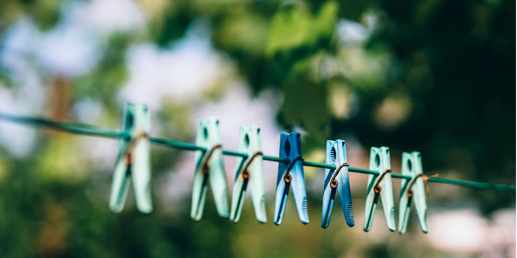 Clothes pegs hanging on a washing line.
