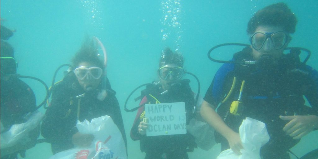 Participants of the Fiji Caqalai program celebrate World Oceans Day with a dive against ocean plastic pollution