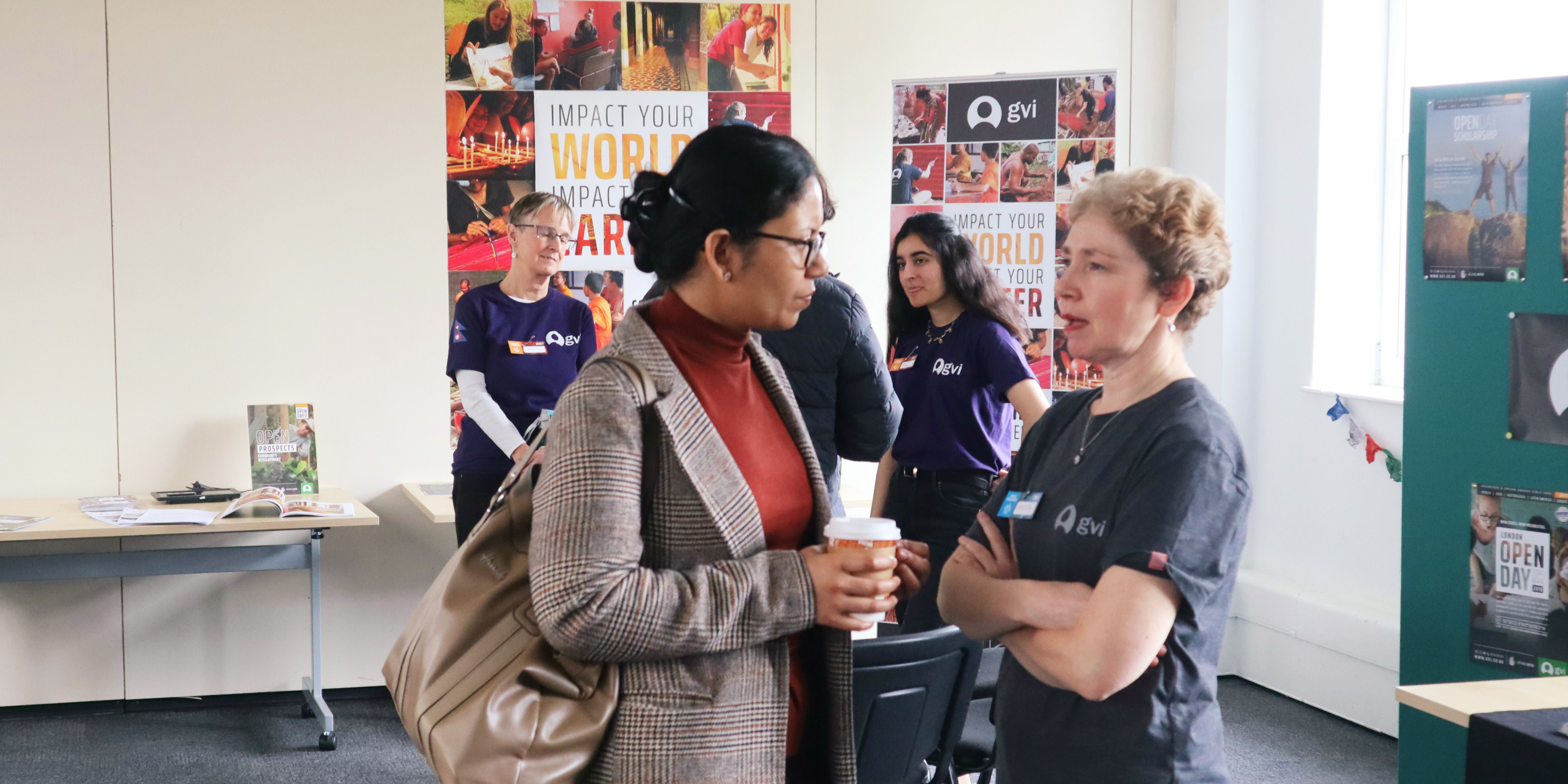 A GVI alumni speaking to an interested woman.