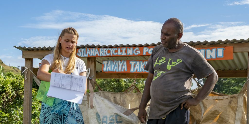 A GVI volunteer tells a man about protecting the environment. 