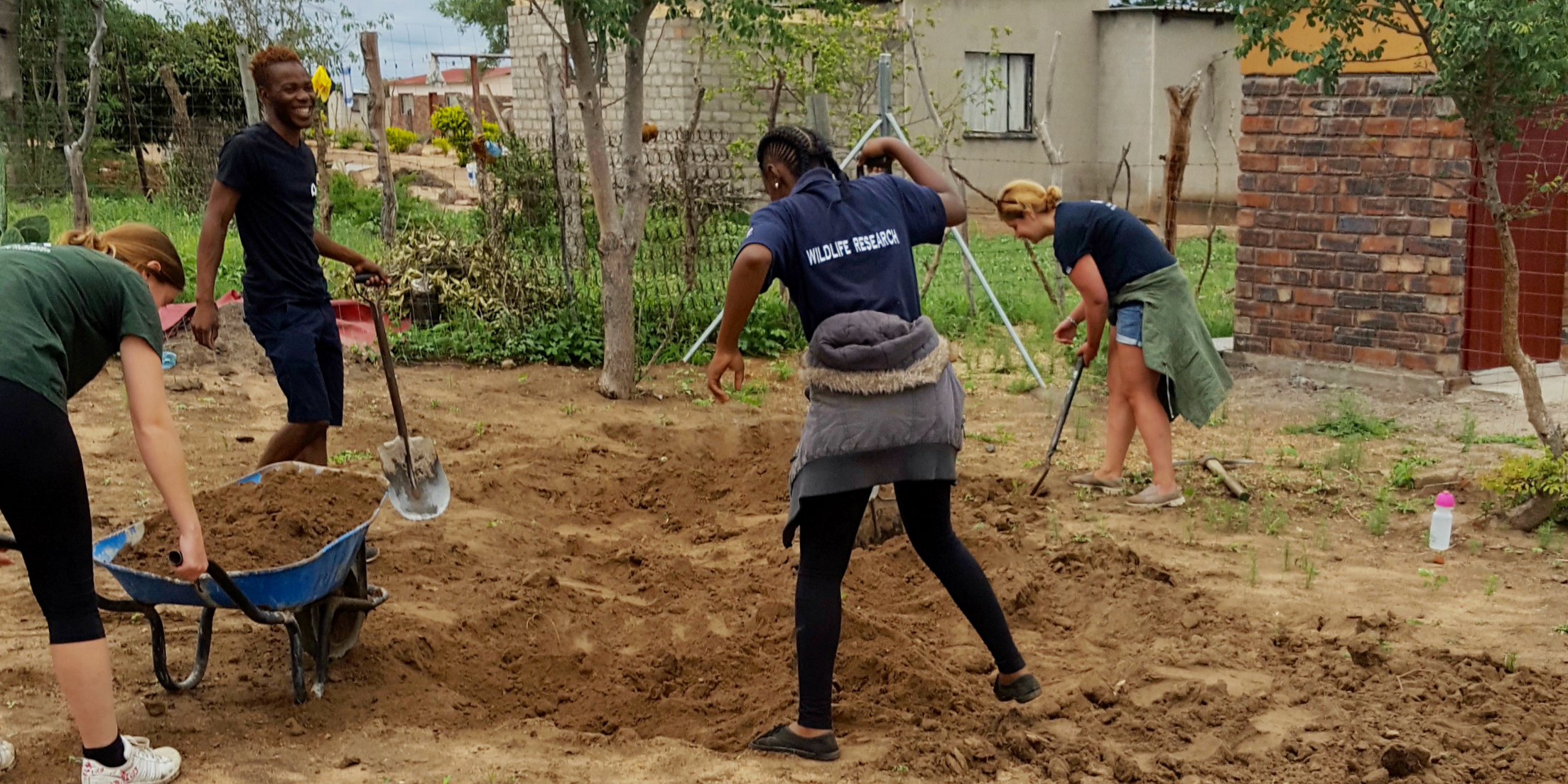 Why volunteer in Africa? You could help to improve educational facilities in Limpopo, South Africa. Pictured: GVI participants break ground on a construction project at a local creche.