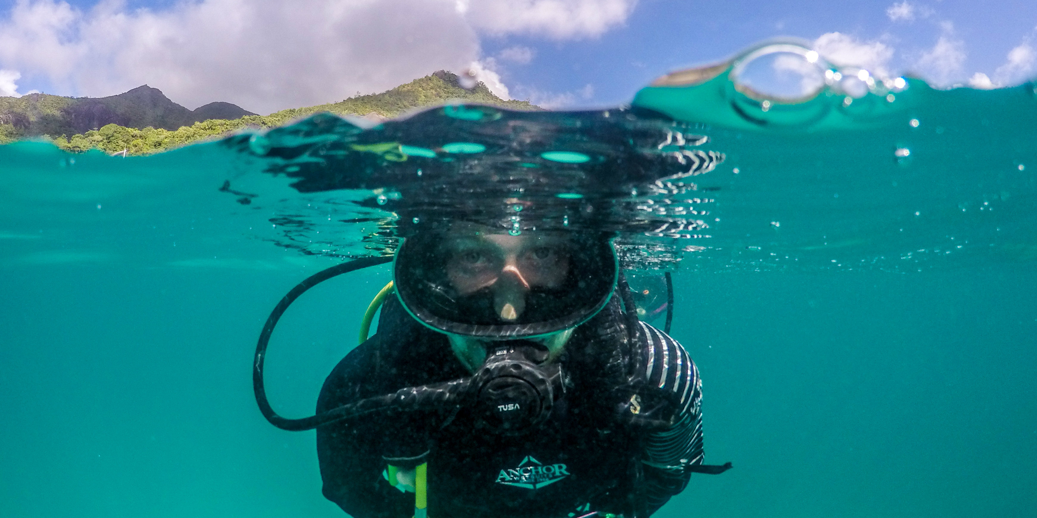 Becoming a PADI certified diver ensures you explore sensitive marine environments responsibly and safely. Pictured: A GVI participant practices diving skills on a marine conservation base.