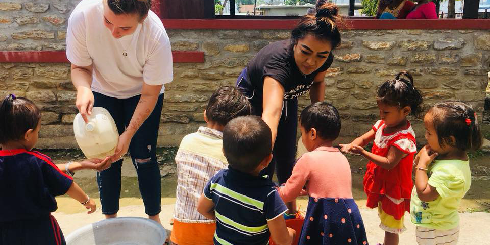 GVI participants show learners how to wash their hands, as part of efforts to promote UN SDG 3: Good Health and Wellbeing.