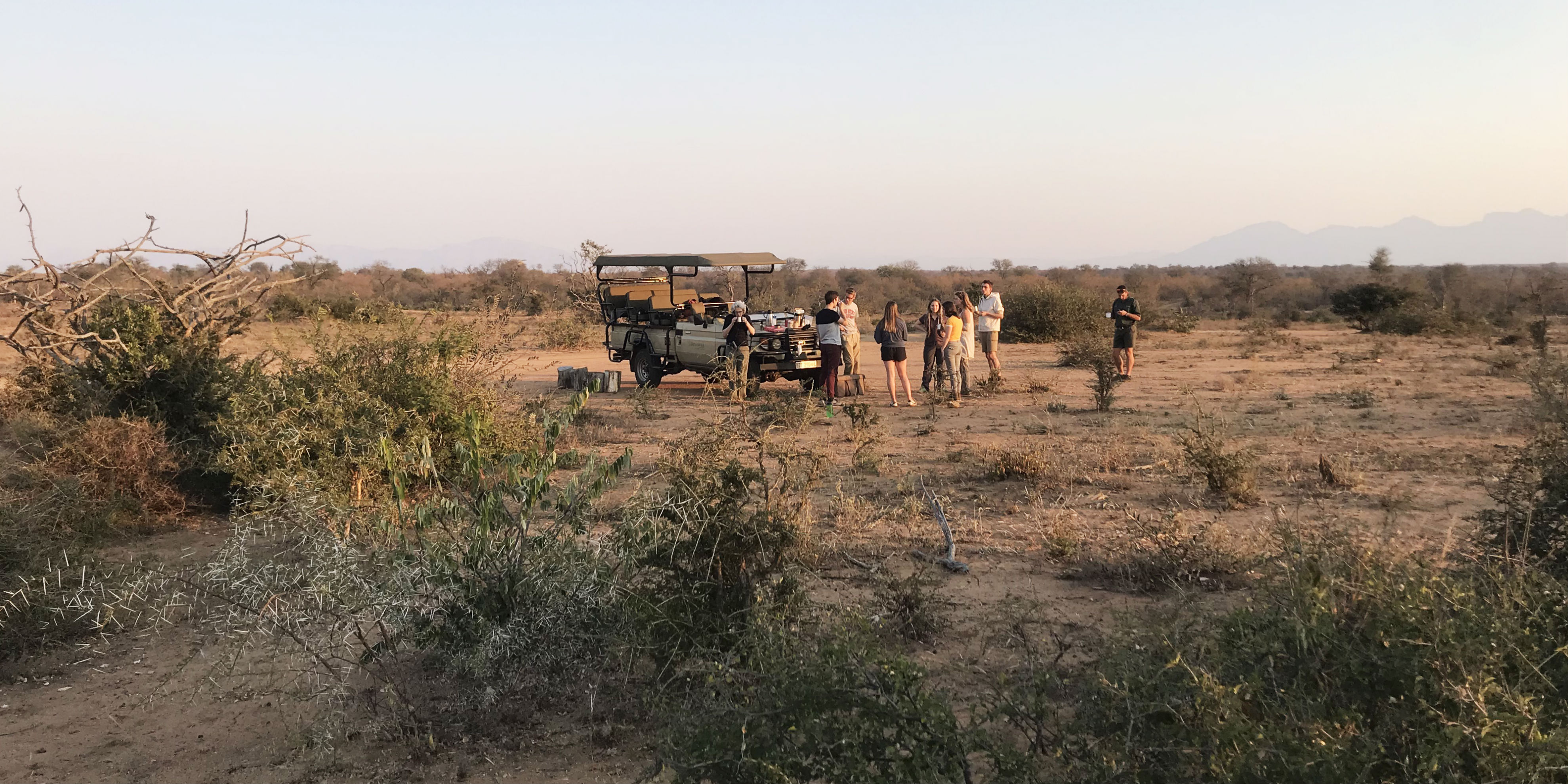 Participants enjoy a cup of coffee in the African bushveld during their gap year program.