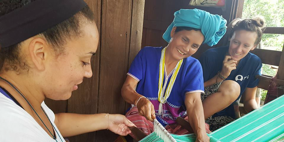 Trained GVI staff provide essential insight into the nuances of the culture of your host country. Pictured: paying volunteers and staff members learn traditional weaving from a women in Chiang Mai. 
