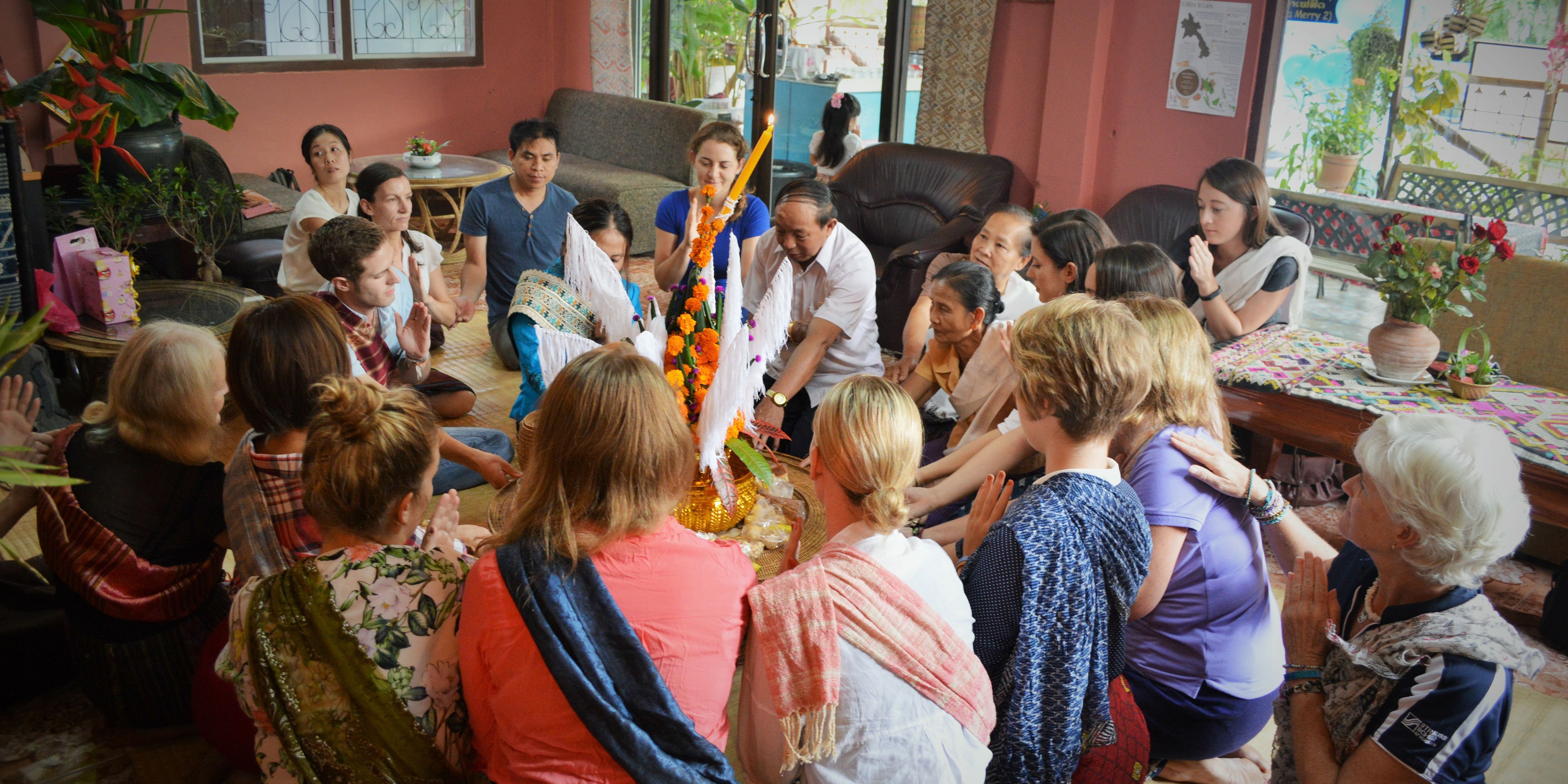 Global citizens take the time to genuinely engage with their host communities. Pictured: GVI participants are invited to participate in a ritual in Laos.