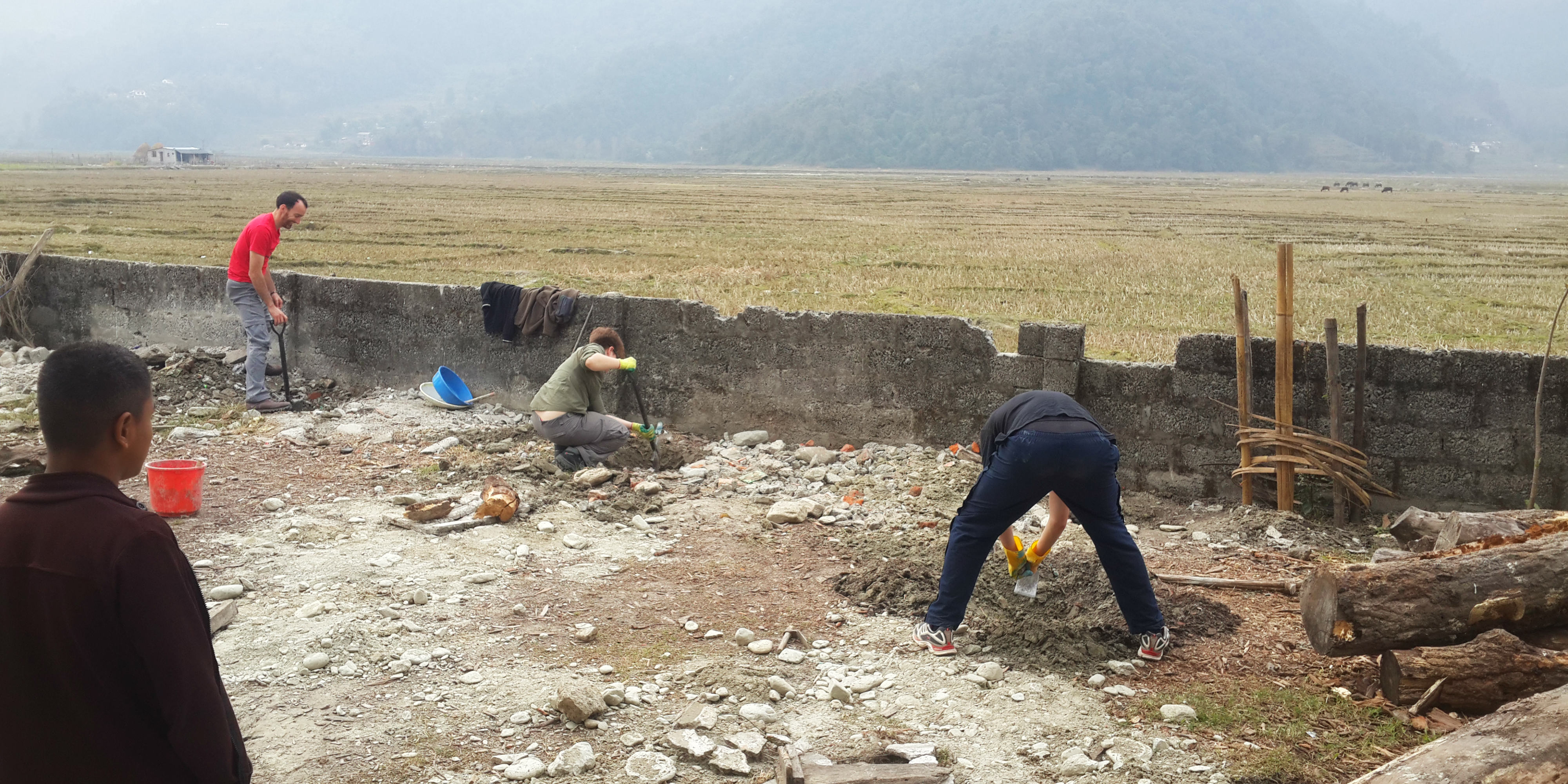 While volunteering in Nepal, participants build a wall around a school, to help ensure the good health and wellbeing of the learners.