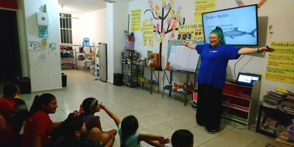 A volunteer teaching children about sharks.