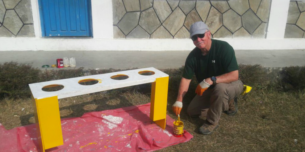 Construction volunteers build teethbrushing stations for children in Nepal, as part of efforts to support Un SDG 3: Good Health and Wellbeing.