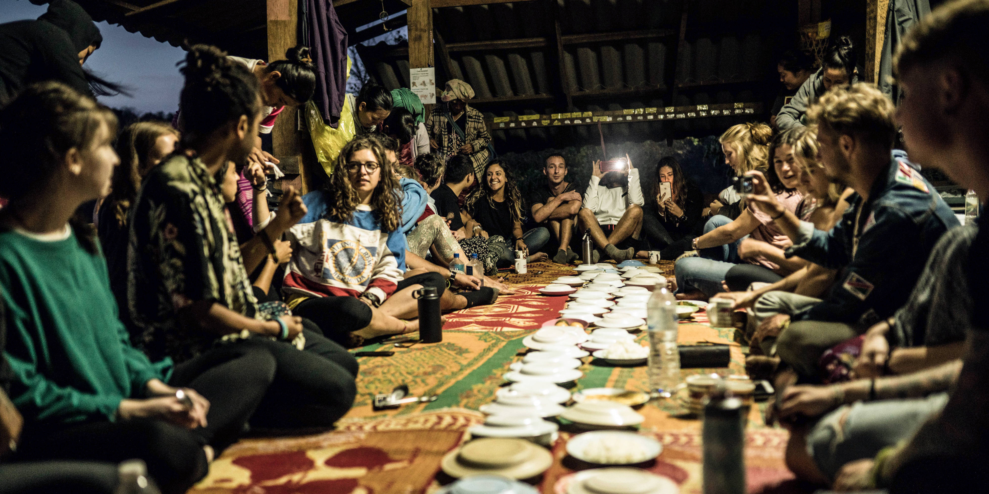 GVI participants share a communal meal in Chiang Mai, while on the program working with elephants in Thailand.