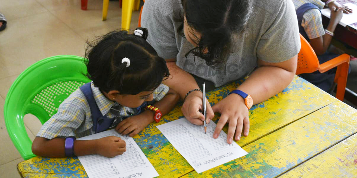 A teaching volunteer works with a student in India. You could gain the crucial in-classroom experience needed from TEFL teachers on a GVI program.
