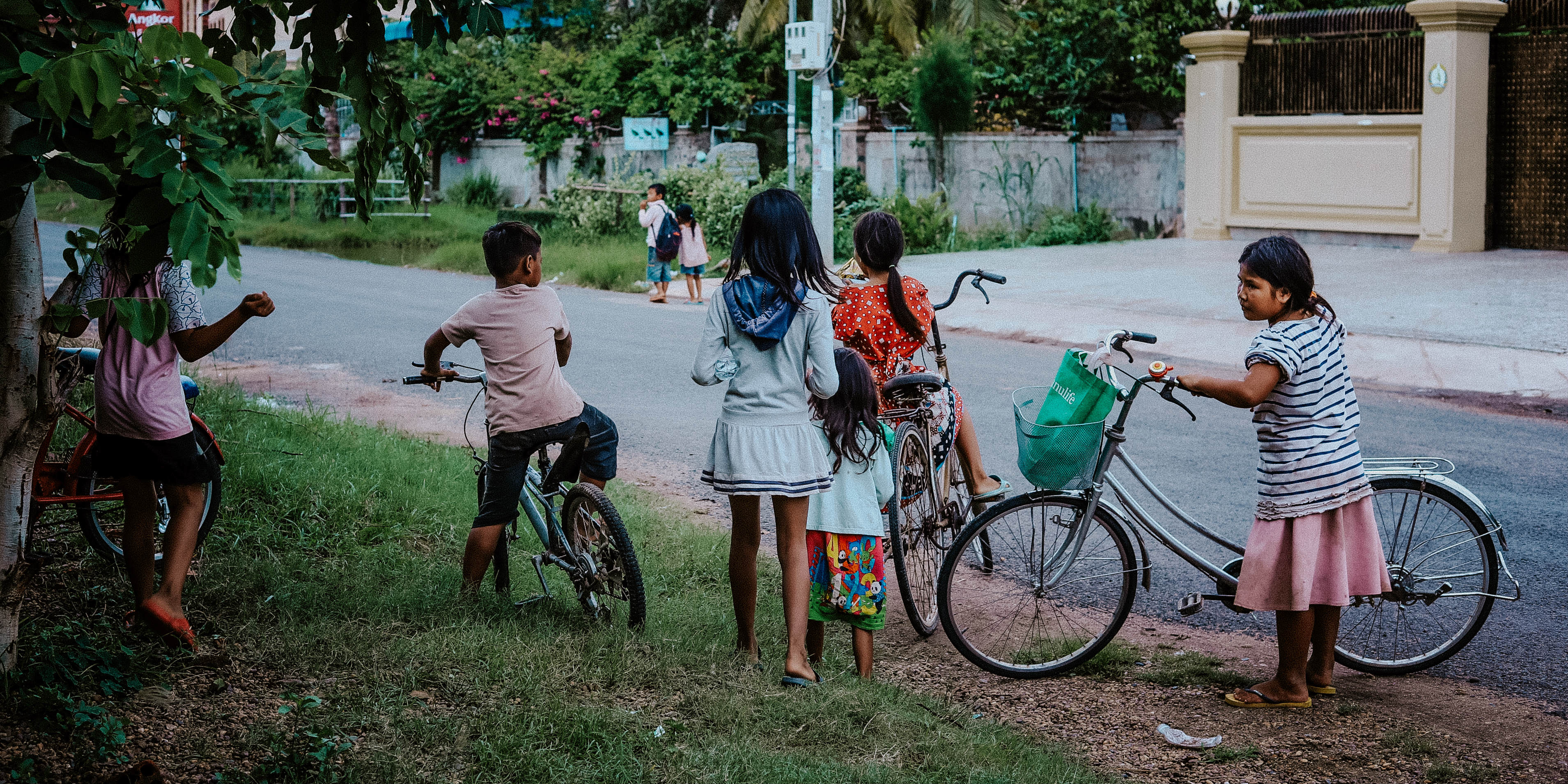 Children in Kampong Cham, Cambodia, ride bicycles home from their English lessons with GVI participants.