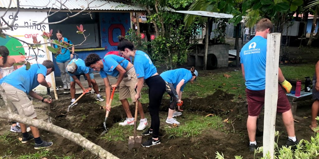 Participants help to prepare a garden while on a gap year before college. 