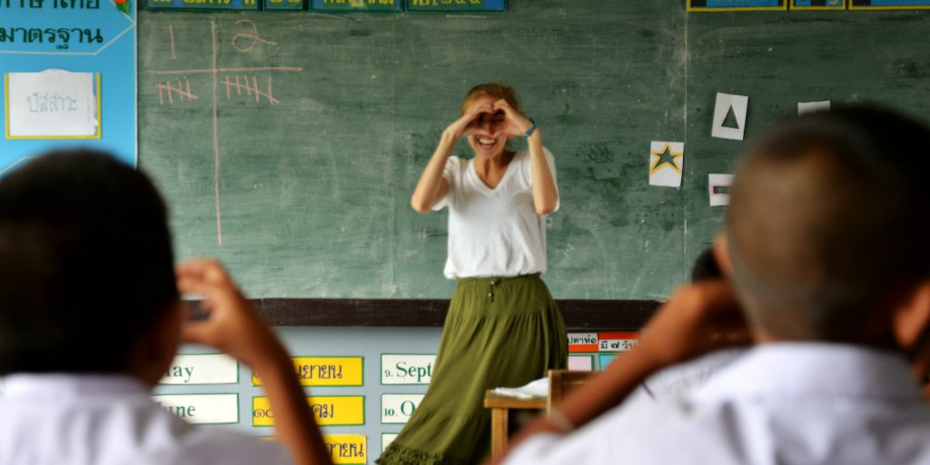 A teaching intern in Thailand teaches students about shapes 