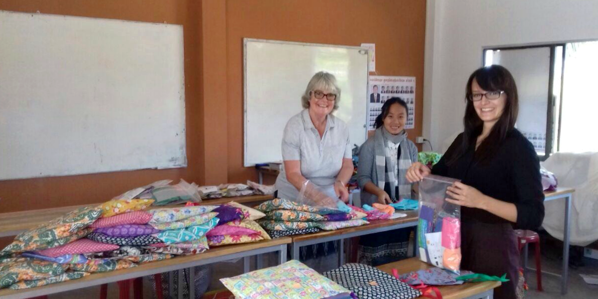 GVI participants prepare menstrual health kits as part of the women's empowerment program in Laos.