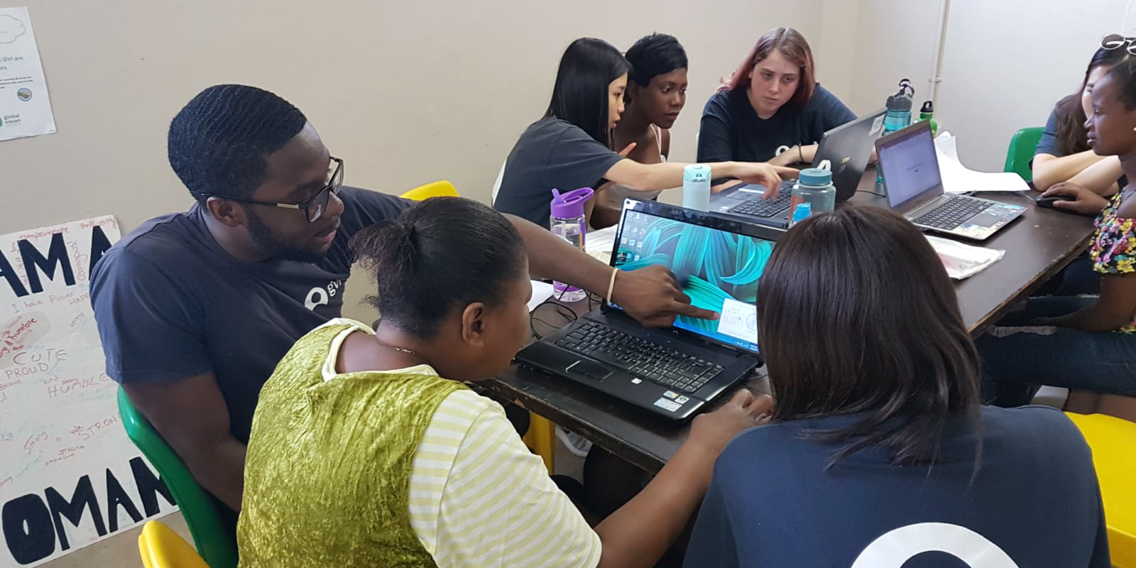 A participant demonstrates how to use a laptop of part of a women's empowerment program.