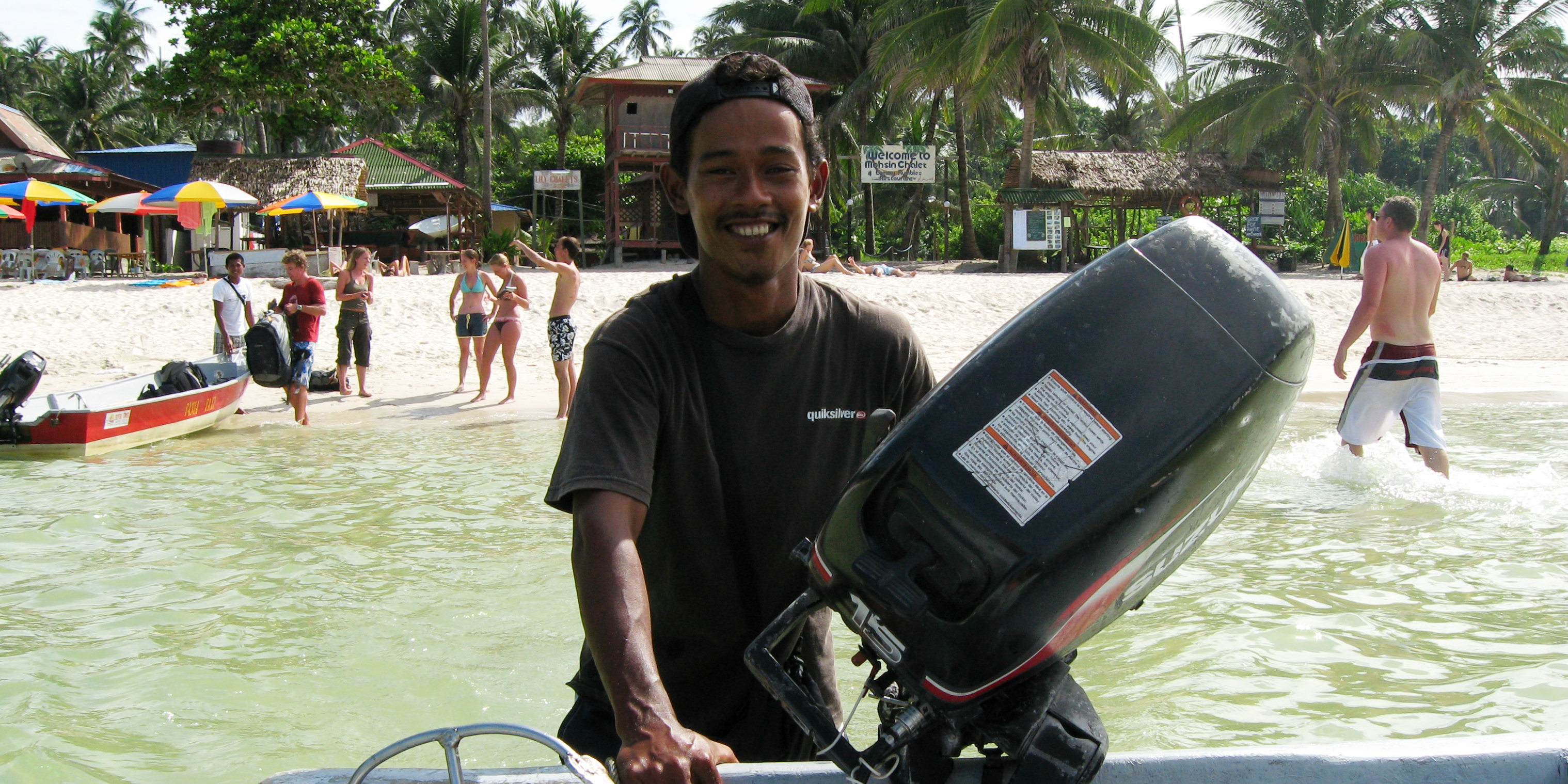 A man helps bring a scuba diving boat back in after one of its scuba diving adventrues.