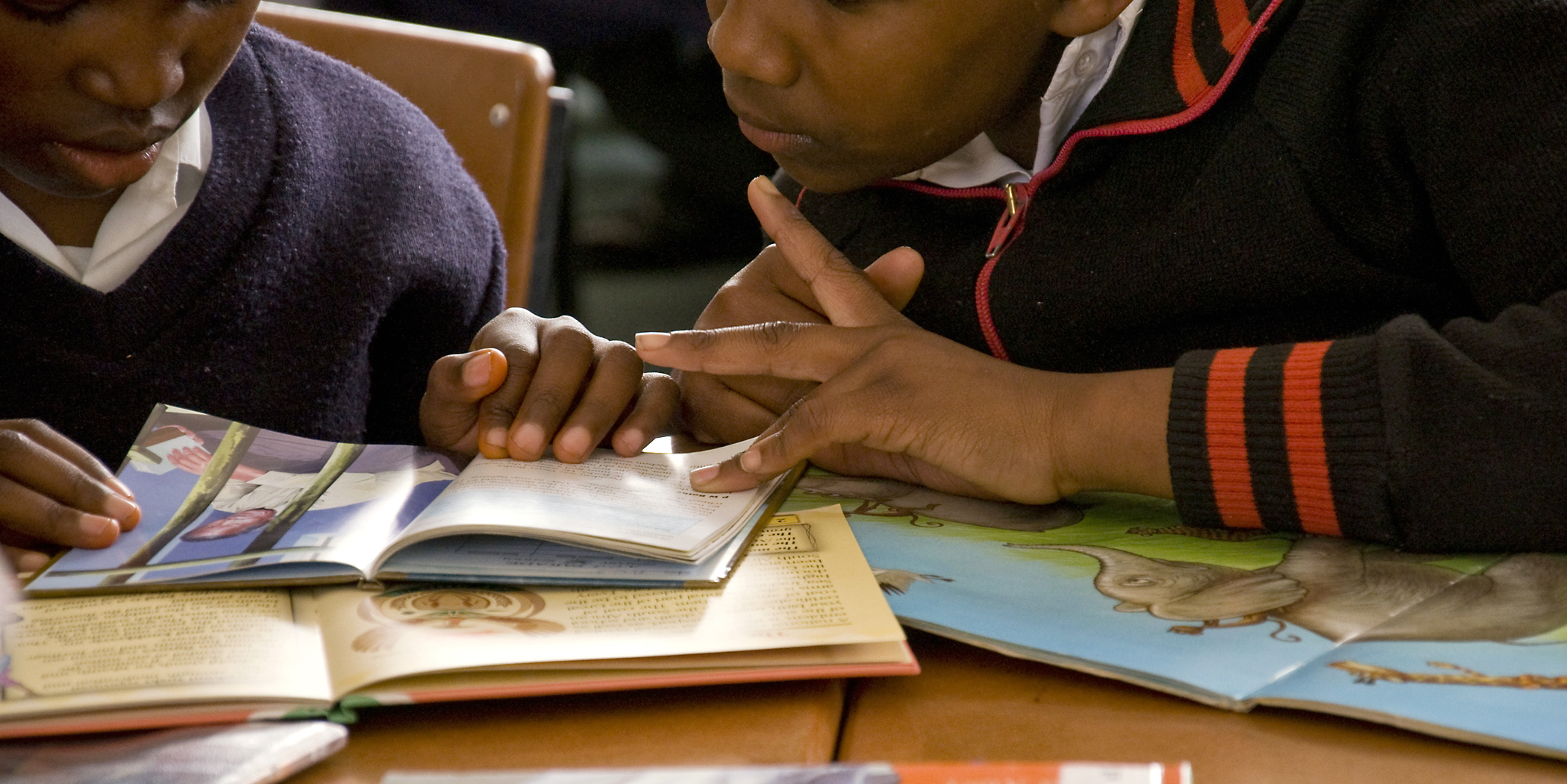 Learners practise their reading as part of a lesson lead by TEFL teachers.