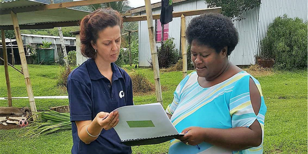 GVI volunteer working with local woman 