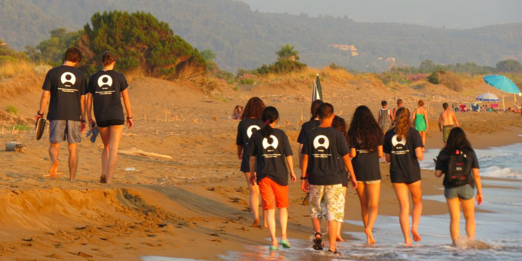 GVI participants walking home during the beach sunset, after a day of volunteering