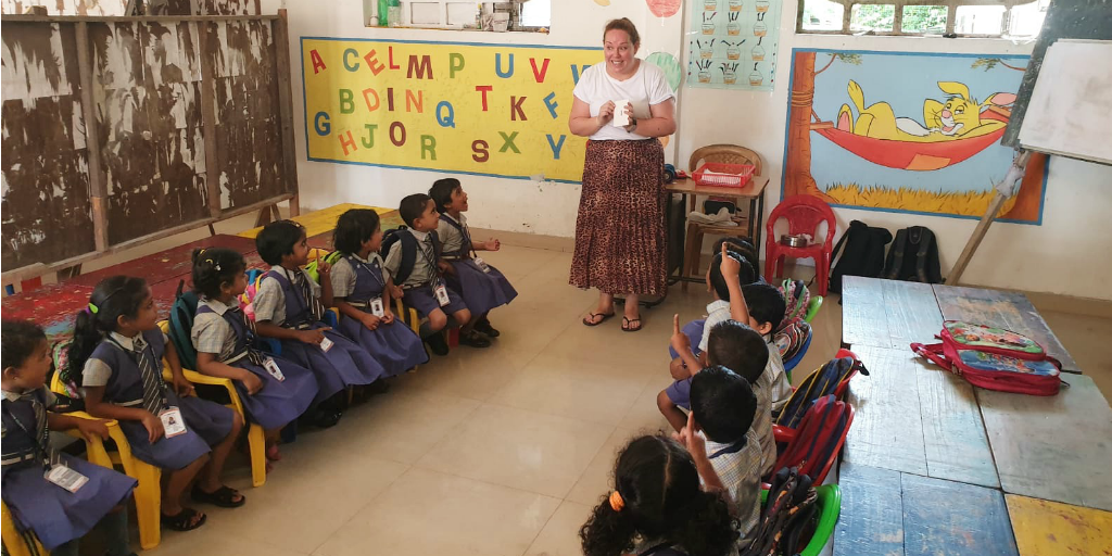 Volunteer teacher with students in Kerala