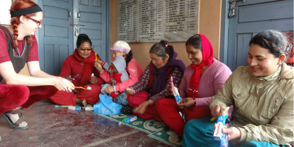 Volunteers teaching women about hygiene practises in India