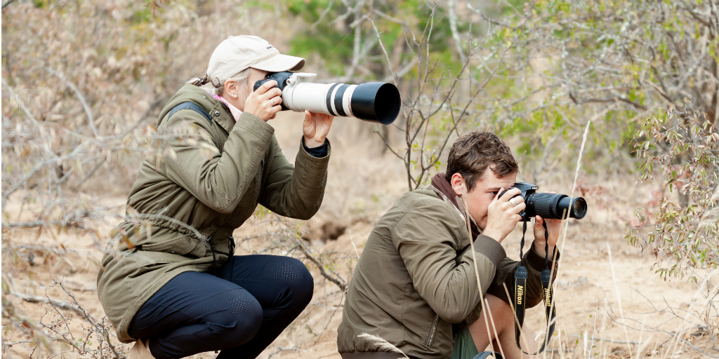 wildlife conservationists taking photographs in the field