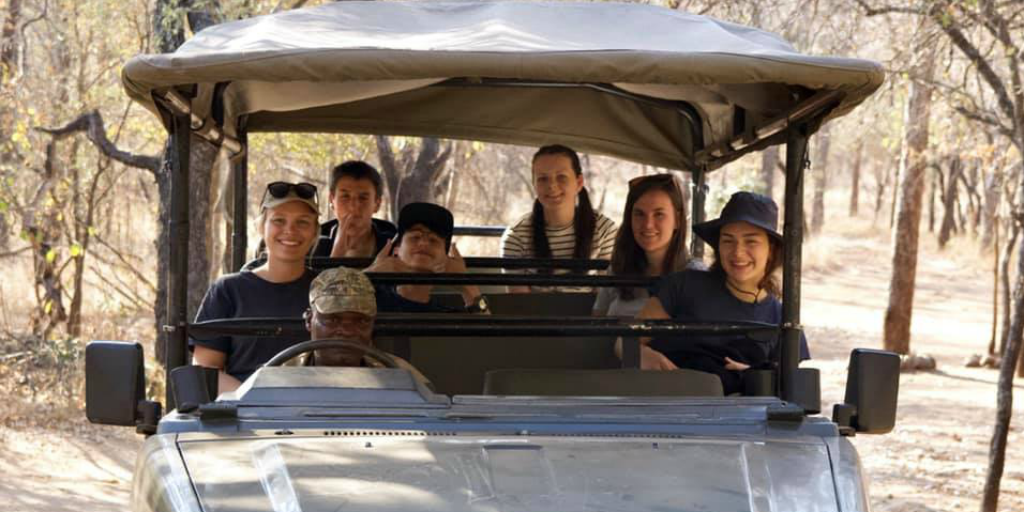 Wildlife volunteers on a safari in a safari jeep