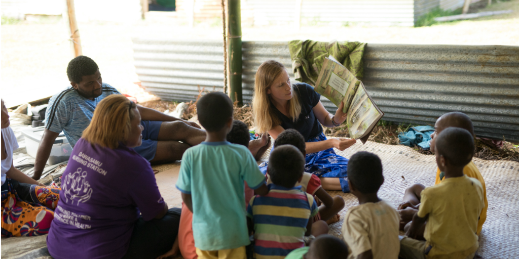 GVI volunteer reading a story to children in Fiji