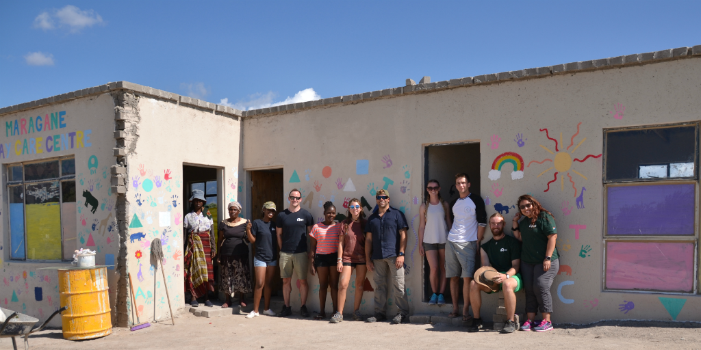 Volunteers and locals standing outside a building