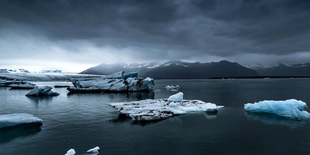 One of the effects of climate change is large areas of ice melting, causing sea levels to rise.