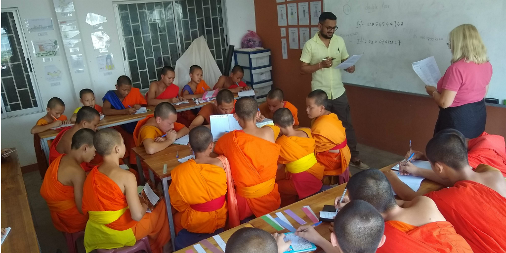 Volunteers teaching English to novice monks in Laos.