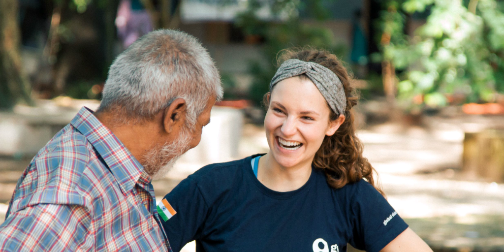 A volunteer speaking to an Indian man