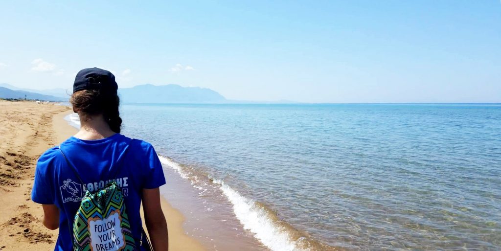 A participant walks along the beach while on a gap year program in Greece.