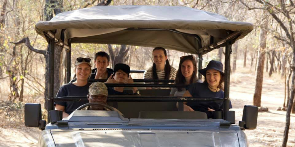 GVI under-18 volunteers in a safari vehicle in South Africa