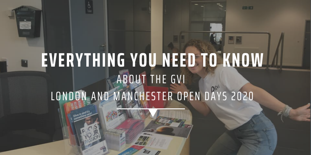 A GVI ambassador posing in front of a GVI Open Day stall.