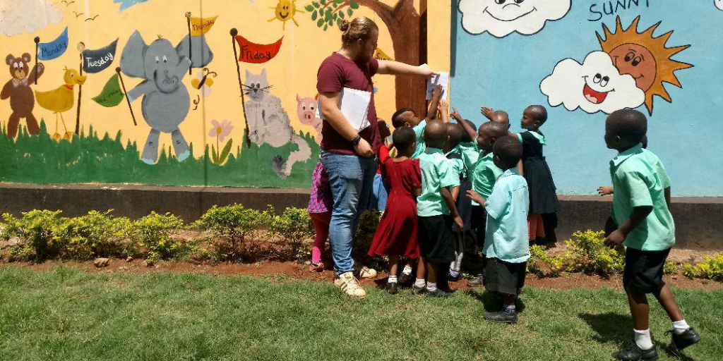 A volunteer teaching students about the environment in Kilimanjaro.