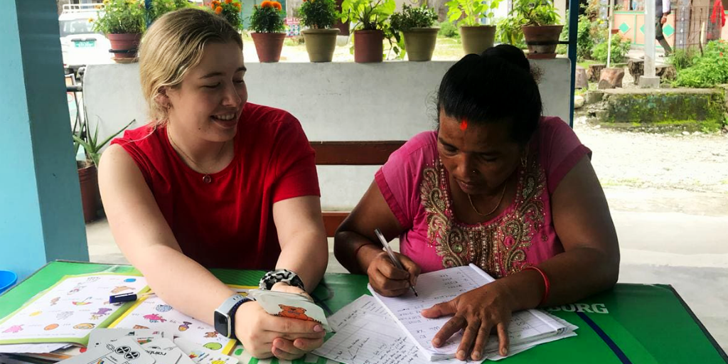 Volunteer teaching english while volunteering in Nepal.