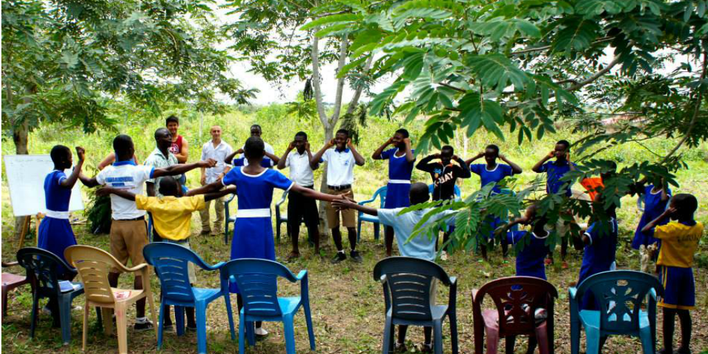 A group session in Ghana taking place in the forest.