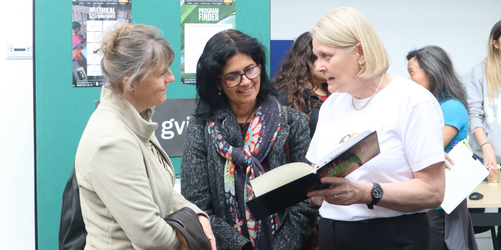 A GVI volunteer having a conversation with two other ladies.