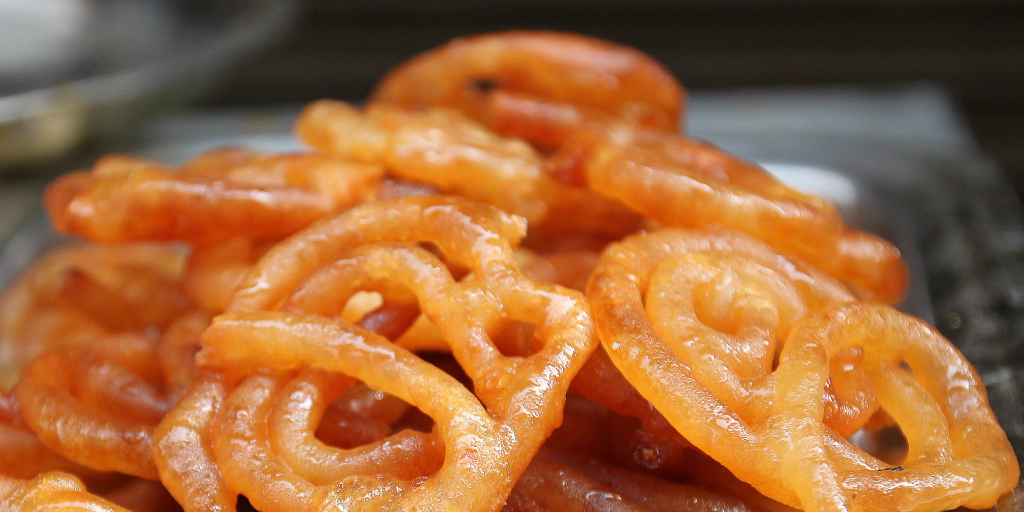 When in India, immerse yourself in culture by trying traditional snacks like jalebi.