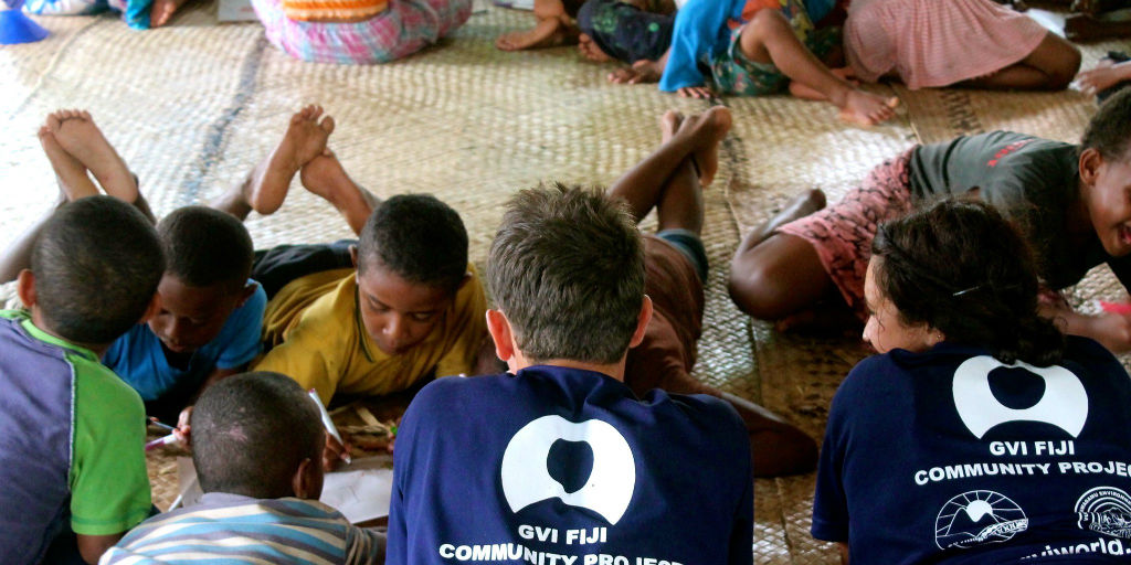 Volunteers helping local children with their schoolwork at GVI base, Fiji.